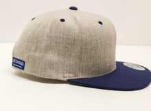 Load image into Gallery viewer, Life&#39;s a Beach Offset Logo Hat - Heather Grey w/ Navy Bill
